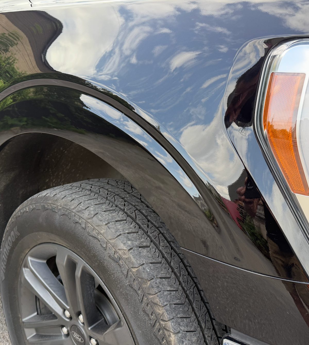 Repaired front fender of a black Ford F-150